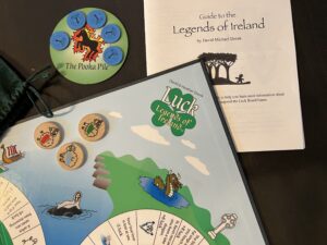 Luck: Legends of Ireland components: Pooka mat and coins, Legends of Ireland Folklore booklet, three sheep tokens, Luck board